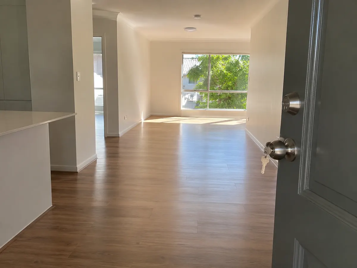Open front door into a clean, empty rental