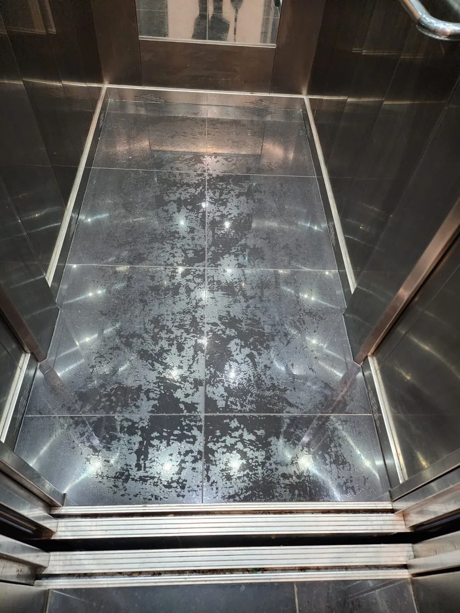 Strata lift floor before cleaning, smeared and dull